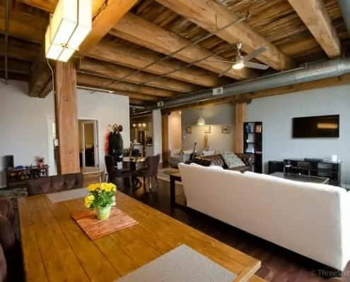 Open living and dining area with massive exposed timber ceilings make this authentic west loop loft uniques space..