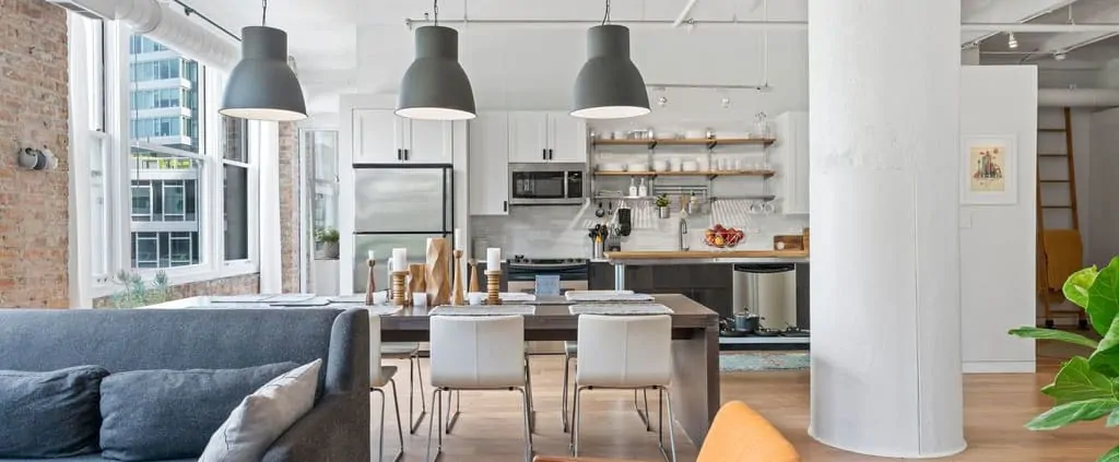 Chicago Condo Improvements That Add The Most Value - On-trend kitchen with new appliances, countertop, and lighting plus white painted cabinets.